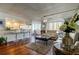 Bright living room with bar kitchen, hardwood floors, and expansive windows at 660 Island Way # 202, Clearwater Beach, FL 33767