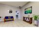 Inviting lobby with comfortable seating, table, modern artwork, and plants at 660 Island Way # 202, Clearwater Beach, FL 33767