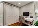 Office space with hardwood floors, a view of the closet, and a grey and white desk at 660 Island Way # 202, Clearwater Beach, FL 33767
