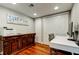 Office area with a wooden cabinet, a white desk, and a view of the large closet at 660 Island Way # 202, Clearwater Beach, FL 33767