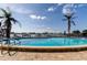 Sparkling pool with waterfront views and palm trees at 660 Island Way # 202, Clearwater Beach, FL 33767