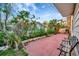 Outdoor patio with seating, greenery, and a charming wrought iron bench at 6709 Cardinal S Dr, St Petersburg, FL 33707