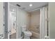 Standard bathroom featuring a toilet, shower/tub combination, and tiled walls at 6916 Stones Throw N Cir # 9110, St Petersburg, FL 33710