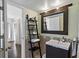 Stylish bathroom features a decorative mirror, ladder shelving, and modern vanity at 6916 Stones Throw N Cir # 9110, St Petersburg, FL 33710
