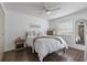 Bedroom featuring hardwood floors, a window, a ceiling fan, and neutral-colored walls at 6916 Stones Throw N Cir # 9110, St Petersburg, FL 33710