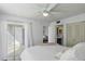 Bright bedroom featuring a private balcony, ensuite bathroom, and a ceiling fan at 6916 Stones Throw N Cir # 9110, St Petersburg, FL 33710