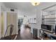Open concept living area with hardwood floors, views of the patio, and access to the kitchen at 6916 Stones Throw N Cir # 9110, St Petersburg, FL 33710