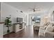 Bright living room with wood floors, modern furniture, and sliding glass doors to the outside at 6916 Stones Throw N Cir # 9110, St Petersburg, FL 33710