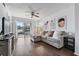 Comfortable living room features hardwood floors, neutral decor, and plenty of natural light at 6916 Stones Throw N Cir # 9110, St Petersburg, FL 33710