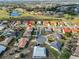 An aerial view of a tan roofed home in a community with a golf course at 701 Baltusrol Way, Sun City Center, FL 33573
