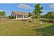 Well-maintained backyard featuring a lush lawn and mature landscaping at 701 Baltusrol Way, Sun City Center, FL 33573