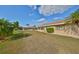 Home's backyard featuring a well-manicured lawn and mature landscaping at 701 Baltusrol Way, Sun City Center, FL 33573