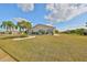 Backyard featuring well-kept lawn and mature landscaping at 701 Baltusrol Way, Sun City Center, FL 33573