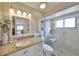 Bright bathroom features granite countertop, updated fixtures, and walk-in shower at 701 Baltusrol Way, Sun City Center, FL 33573