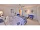 Well-lit bedroom showcasing neutral colors, plush carpet, and a ceiling fan at 701 Baltusrol Way, Sun City Center, FL 33573
