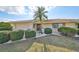 Charming single story home with attached garage; the lawn is green and the foliage is neatly trimmed at 701 Baltusrol Way, Sun City Center, FL 33573