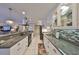 Bright kitchen featuring granite countertops, white cabinets, stainless appliances and decorative lighting at 701 Baltusrol Way, Sun City Center, FL 33573