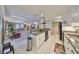 Open kitchen featuring stainless steel appliances, breakfast bar, and views to the living area at 701 Baltusrol Way, Sun City Center, FL 33573