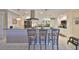 Eat-in kitchen with granite countertops, tiled floor, stainless appliances, and bar seating at 701 Baltusrol Way, Sun City Center, FL 33573