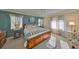 Cozy main bedroom showcasing a king bed, soft carpet, two bedside tables, and soft window treatments at 701 Baltusrol Way, Sun City Center, FL 33573