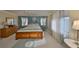 Bright and airy main bedroom with soft carpet, king bed, and light-filtering curtains on the windows at 701 Baltusrol Way, Sun City Center, FL 33573