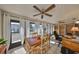 Sun-drenched sunroom offers lots of natural light with many windows and a ceiling fan for comfort at 701 Baltusrol Way, Sun City Center, FL 33573