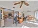 Bright sunroom features tile floors, ceiling fans, and sliding glass doors to the living room, dining area and backyard at 701 Baltusrol Way, Sun City Center, FL 33573