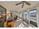 Inviting sunroom filled with light, featuring a tile floor, lots of windows, and a ceiling fan at 701 Baltusrol Way, Sun City Center, FL 33573