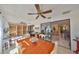 Spacious sunroom with dining and desk area, featuring tile floors and sliding doors to the living room at 701 Baltusrol Way, Sun City Center, FL 33573