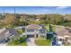 An aerial shot of a lovely two-story home surrounded by lush green lawns and a quaint neighborhood setting with mature trees at 7112 Samuel Ivy Dr, Tampa, FL 33619