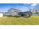 Spacious backyard with a screened-in patio perfect for outdoor entertaining at 7112 Samuel Ivy Dr, Tampa, FL 33619