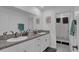 Bathroom with double sink vanity, granite countertops, and a separate shower at 7112 Samuel Ivy Dr, Tampa, FL 33619