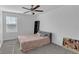 Bedroom featuring a comfortable bed, ceiling fan, and a sleek modern design at 7112 Samuel Ivy Dr, Tampa, FL 33619