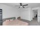 Cozy bedroom features a ceiling fan, closet, and neutral gray carpet at 7112 Samuel Ivy Dr, Tampa, FL 33619