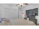 Relaxing bedroom with light walls, a ceiling fan, and a bed adorned with floral bedding, beside a TV with a closet at 7112 Samuel Ivy Dr, Tampa, FL 33619