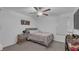 Bedroom featuring a cozy bed, ceiling fan, and calming neutral colors at 7112 Samuel Ivy Dr, Tampa, FL 33619