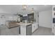 Open-concept kitchen featuring stainless steel appliances, modern white cabinets, and an island with seating at 7112 Samuel Ivy Dr, Tampa, FL 33619