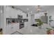 Bright and airy kitchen showcasing an island with a light countertop, white cabinetry, and modern stainless-steel appliances at 7112 Samuel Ivy Dr, Tampa, FL 33619