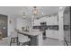Modern kitchen featuring a center island with bar stool seating, sleek appliances, and stylish subway tile backsplash at 7112 Samuel Ivy Dr, Tampa, FL 33619