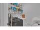 Practical laundry room with modern washer and dryer, storage shelves, and hanging rod at 7112 Samuel Ivy Dr, Tampa, FL 33619