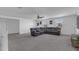 Spacious living room with a large sectional sofa, ceiling fan, and bright natural light at 7112 Samuel Ivy Dr, Tampa, FL 33619