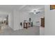 Bright living area with neutral walls, tiled floor, a ceiling fan, and furniture including work-from-home space at 7112 Samuel Ivy Dr, Tampa, FL 33619