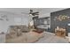 Bright and stylish living room featuring tile floors, dark accent wall, and comfortable neutral furniture at 7112 Samuel Ivy Dr, Tampa, FL 33619