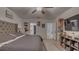Relaxing main bedroom with a gray quilted bed, ceiling fan, and easy access to closets and bath at 7112 Samuel Ivy Dr, Tampa, FL 33619