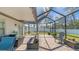 Spacious screened patio with a hammock, lounge seating and outdoor dining set at 7112 Samuel Ivy Dr, Tampa, FL 33619