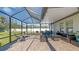 Relaxing screened patio with brick pavers and comfortable outdoor furniture at 7112 Samuel Ivy Dr, Tampa, FL 33619