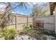 A backyard with a wood fence and green foliage creates a private garden space at 7912 Tangerine Dr, Temple Terrace, FL 33637