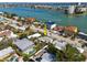 Aerial shot of a waterfront community with a house near the bay, showcasing the lifestyle and community features at 8050 Boca Ciega Dr, St Pete Beach, FL 33706