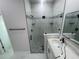 Updated bathroom features a glass shower with tiled walls, pebble floor and built-in shelves at 8204 Chimney Rock Dr, Webster, FL 33597