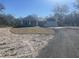 New construction home with a light blue facade, an attached garage, and a sand and grass lawn and asphalt driveway at 8204 Chimney Rock Dr, Webster, FL 33597